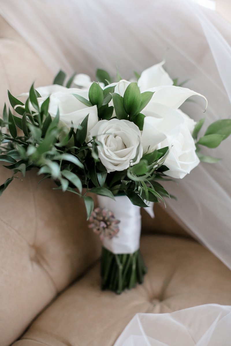 Classic and simple all white wedding bouquet for military bride with calla lilies and greenery