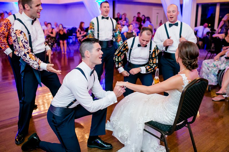 Funny groom and groomsmen singing to the bride at wedding reception at Fredericksburg Country Club in Virginia