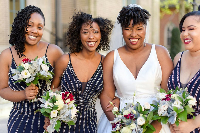 Beautiful bridesmaids in dark navy blue dresses with silver beaded details for winter wedding