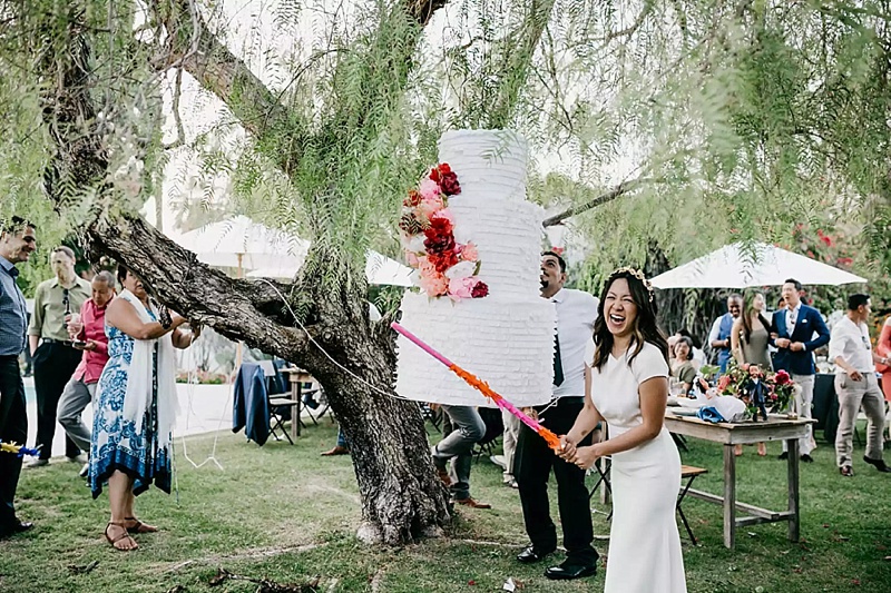 Cute wedding cake pinata for outdoor wedding games