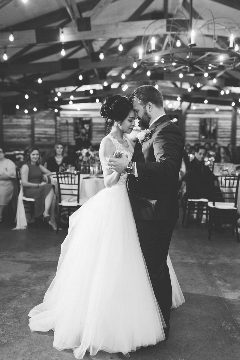 Romantic first dance moment in barn with bride and groom at New Kent Winery in Virginia