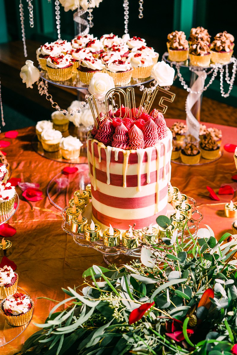 Red white and gold wedding cake and cupcake display for a chic intimate wedding desserts at the Virginia Living Museum in Newport News