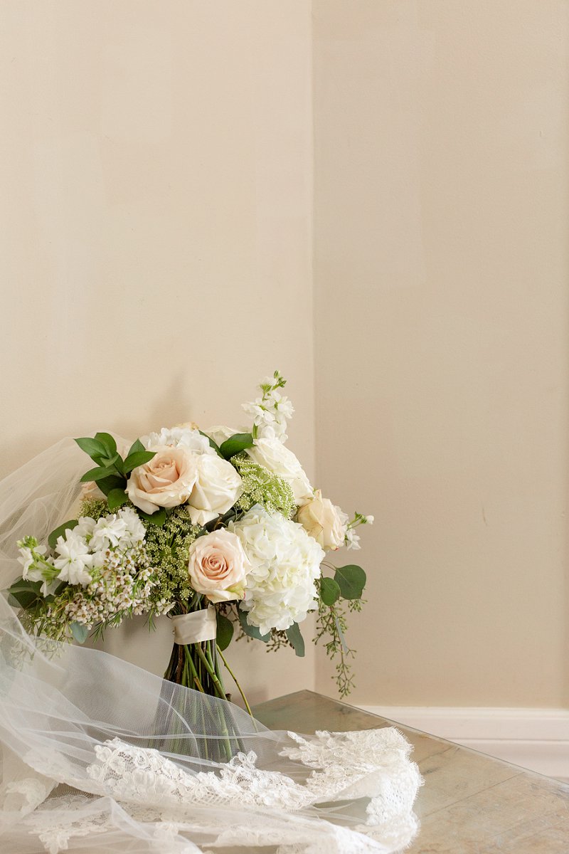 Classic all white and pink beach wedding bouquet with white hydrangeas and wax flowers