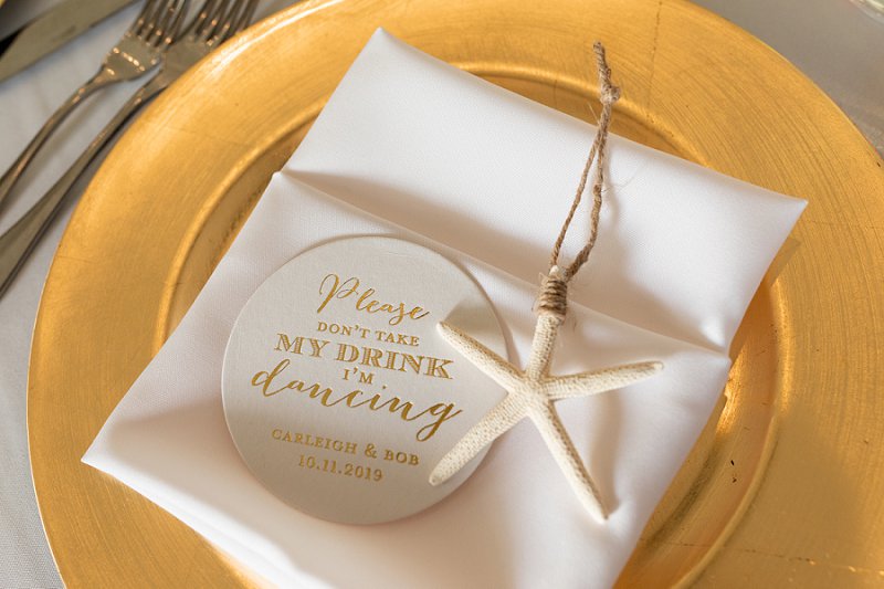 Personalized Drink Keeper coasters for fun beach wedding detail on guest place settings with a white starfish