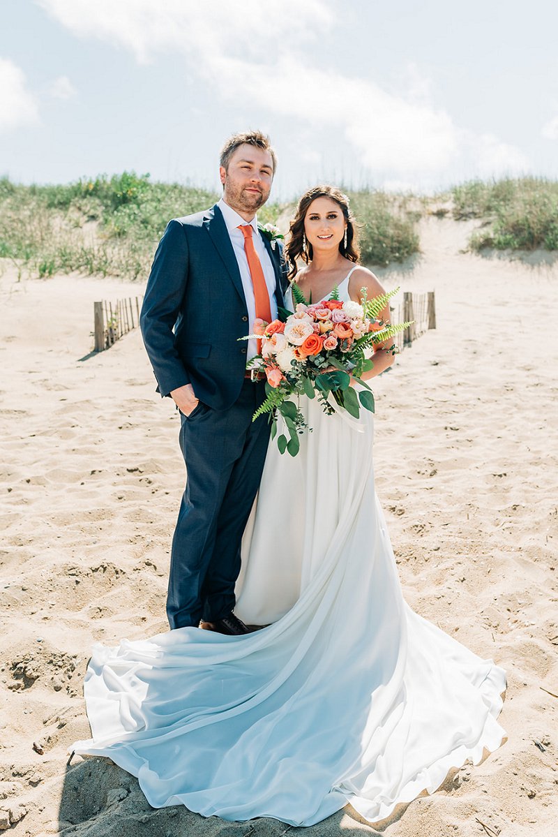 Beach bride and groom for an orange modern wedding in the Outer Banks