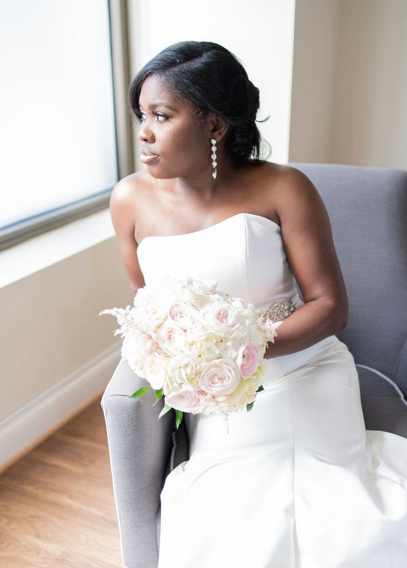 Gorgeous black bride with long chandelier earrings and chic updo for classic ballroom wedding in Richmond Virginia