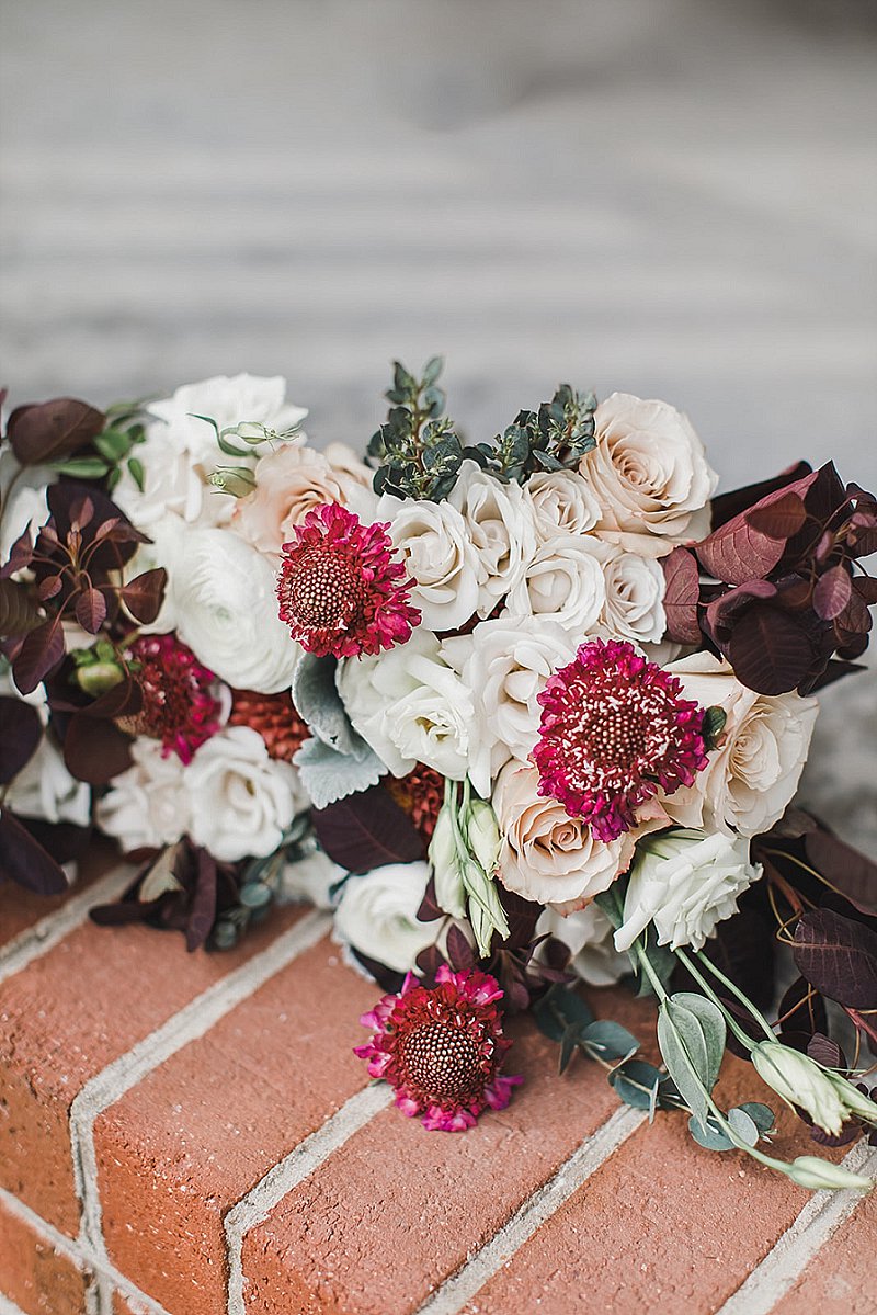 Gorgeous moody fall wedding bouquet with burgundy and white flowers