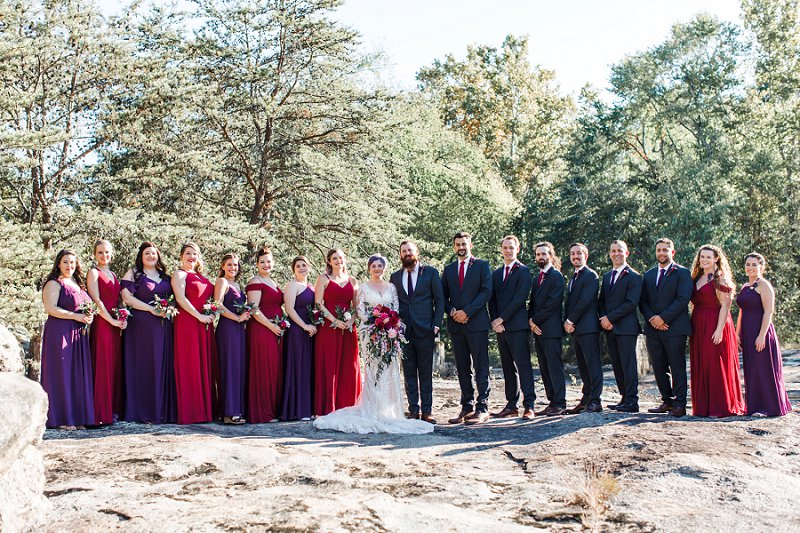 Wedding party in gray suits and gorgeous purple plum bridesmaid dresses for fall vintage wedding at Mill at Fine Creek in Powhatan Virginia