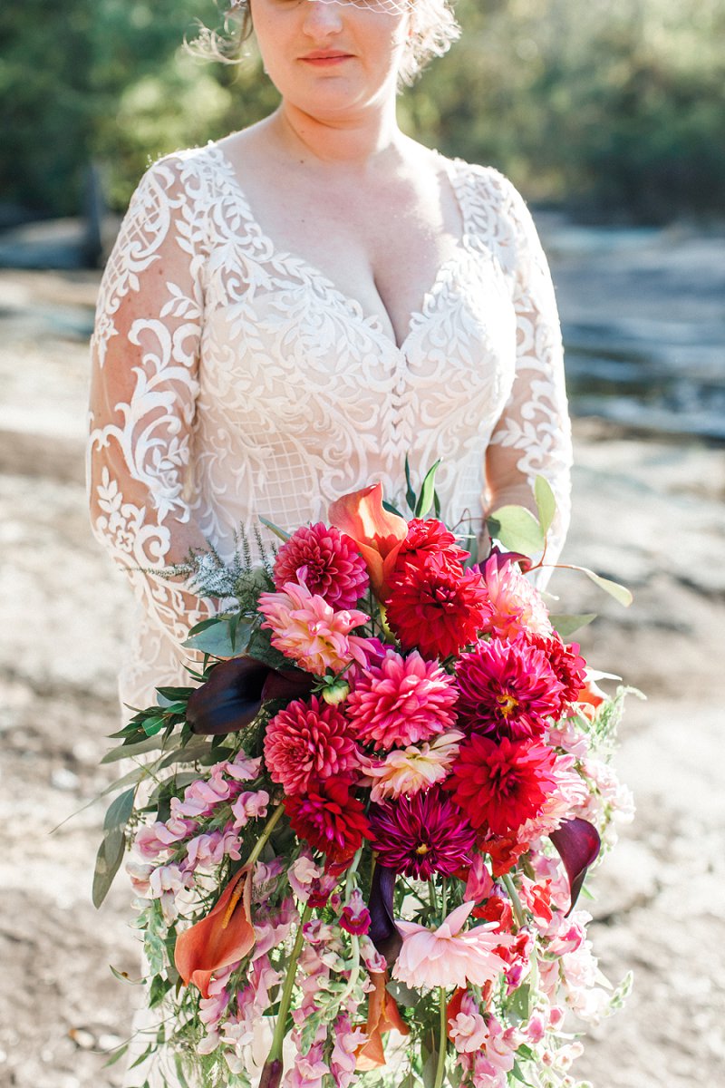 Beautiful fall inspired cascading bridal bouquet with dark pink dahlias and purple calla lilies for the ultimate dramatic floral statement