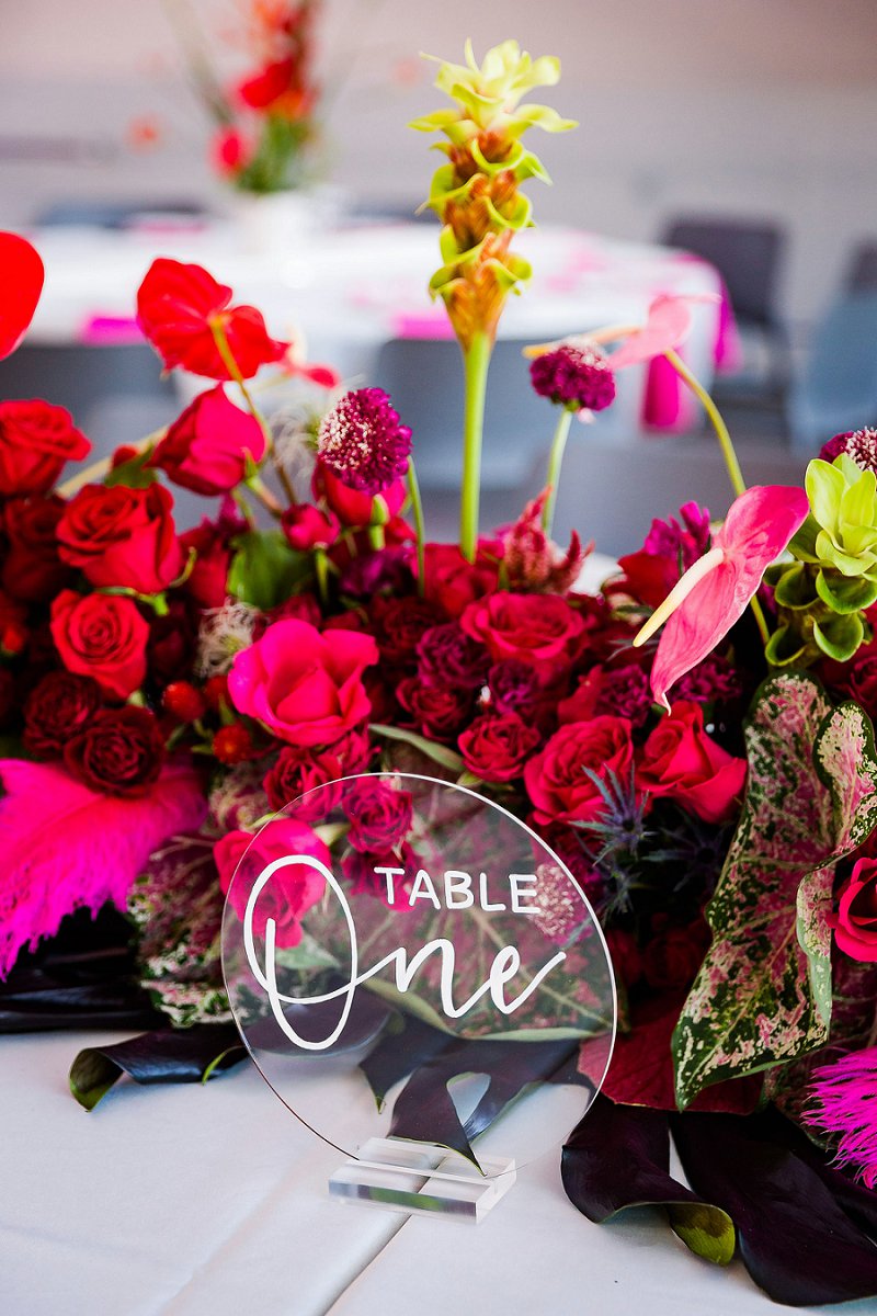 Round acrylic wedding table number with colorful ombre wedding floral centerpieces for unique modern wedding ideas