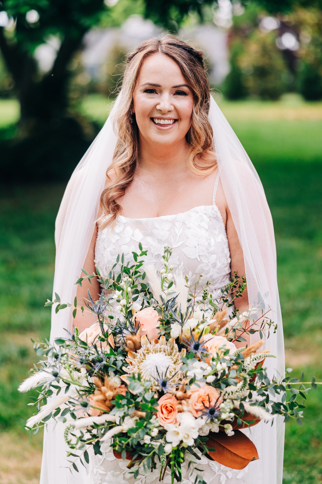 Madi Lane wedding dress with spaghetti straps and floral appliques