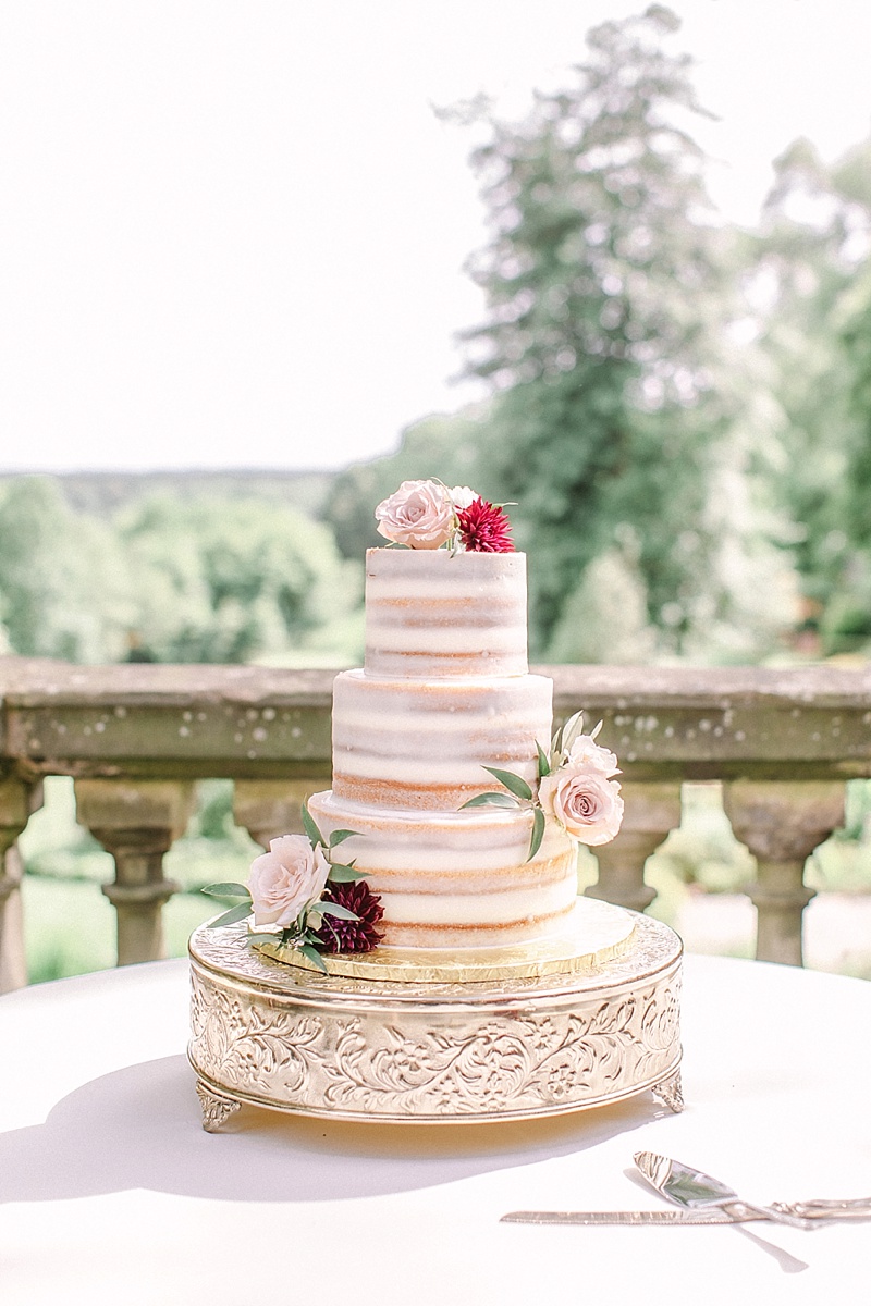 Semi naked wedding cake with pink and red flower decorations at Virginia House in Richmond Virginia