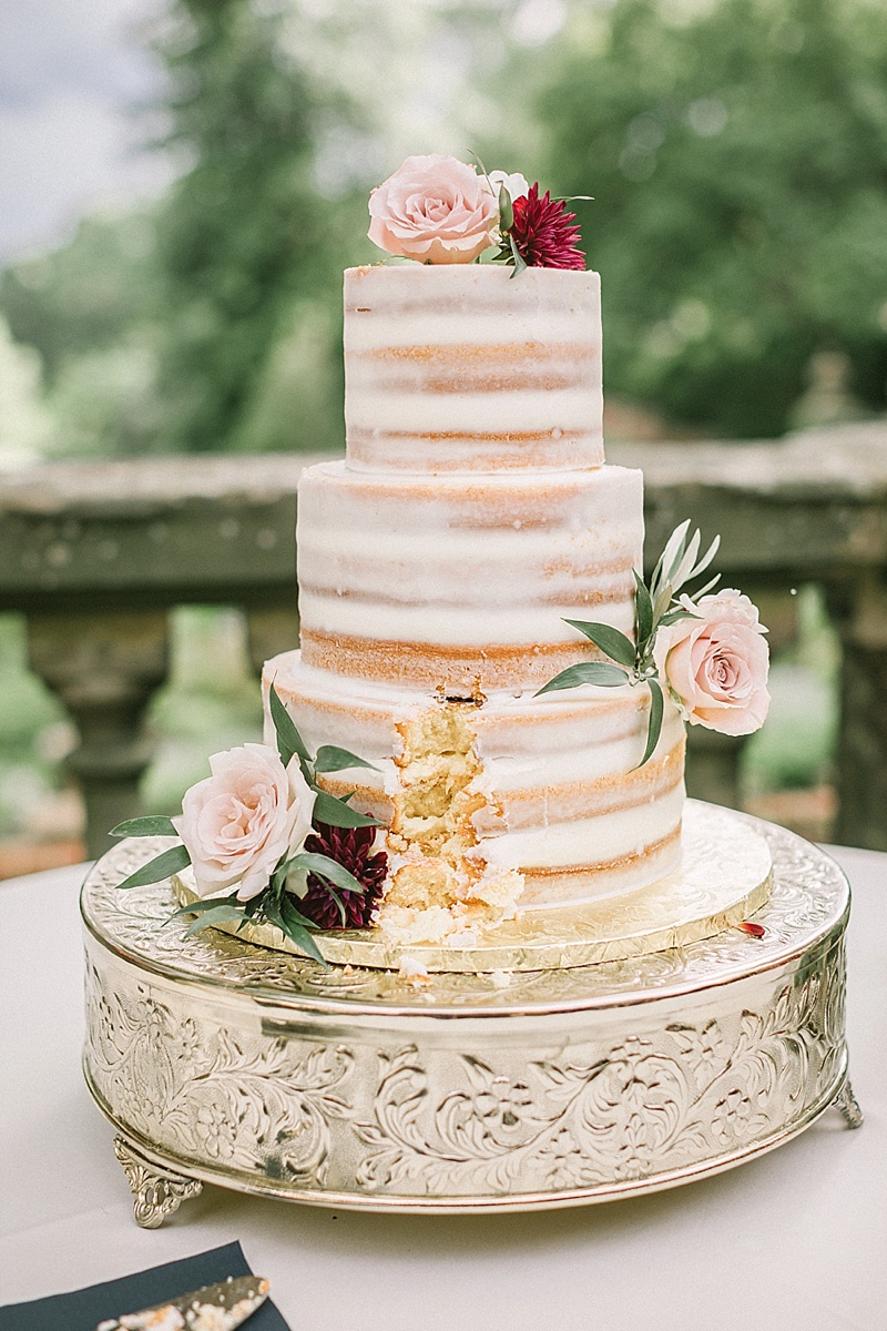 Semi naked wedding cake with pink and red flower decorations at Virginia House in Richmond Virginia