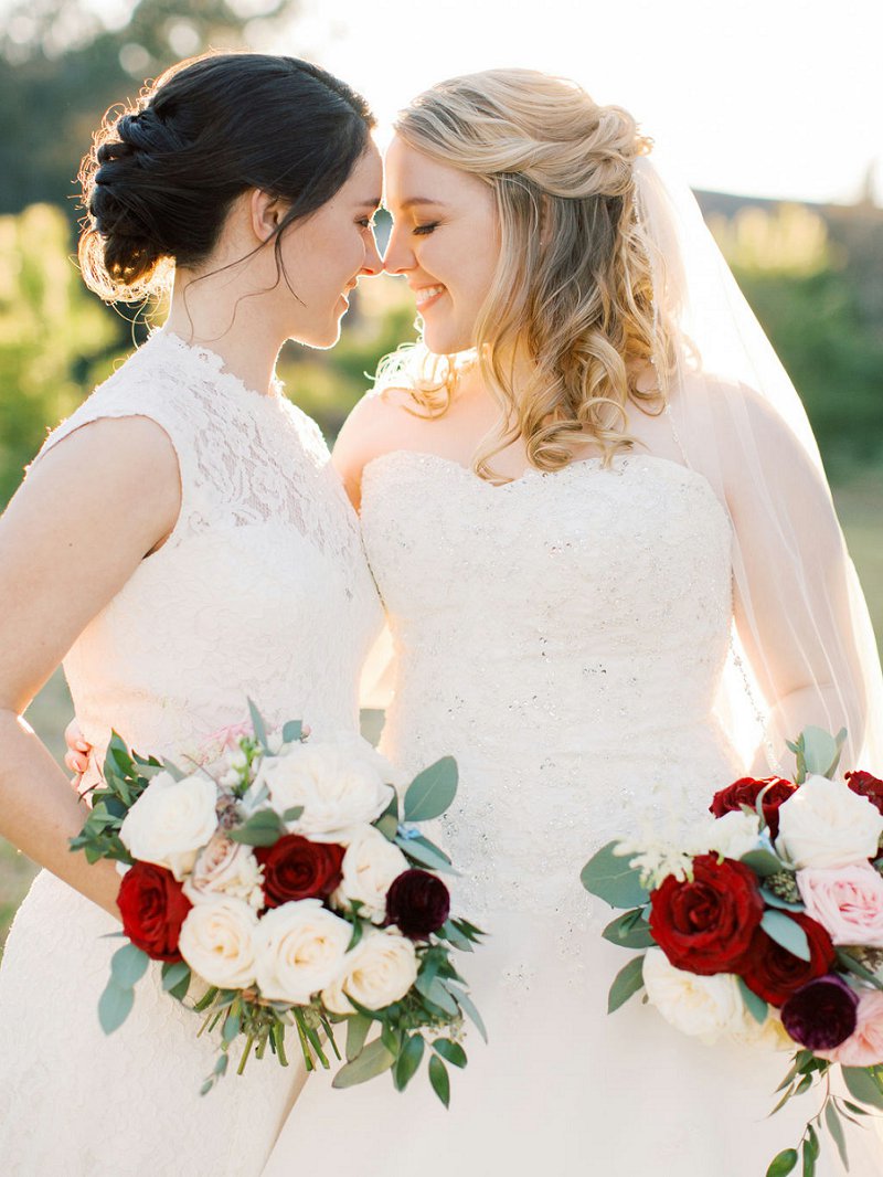 Romantic LGBTQ wedding day at Williamsburg Winery in Virginia with two brides in complementary lace bridal gowns